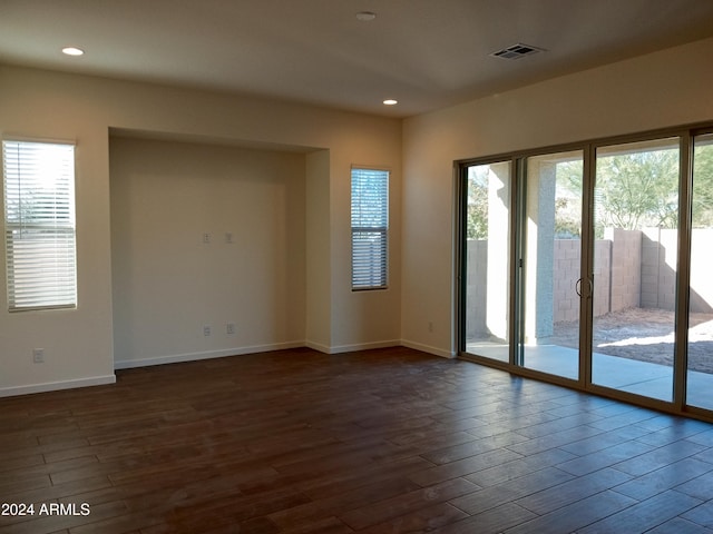 empty room with dark hardwood / wood-style flooring