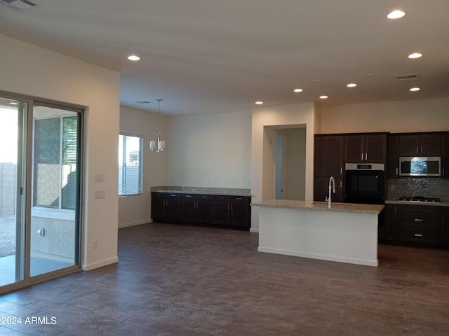 kitchen with decorative light fixtures, stainless steel appliances, a chandelier, and dark wood-type flooring