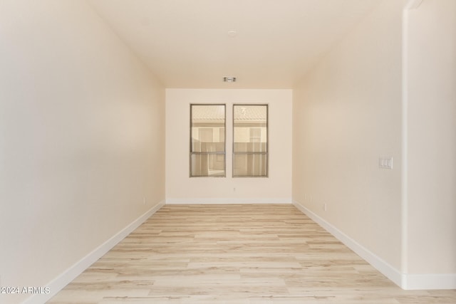 empty room with light hardwood / wood-style flooring