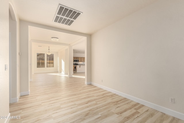 unfurnished room with light hardwood / wood-style floors