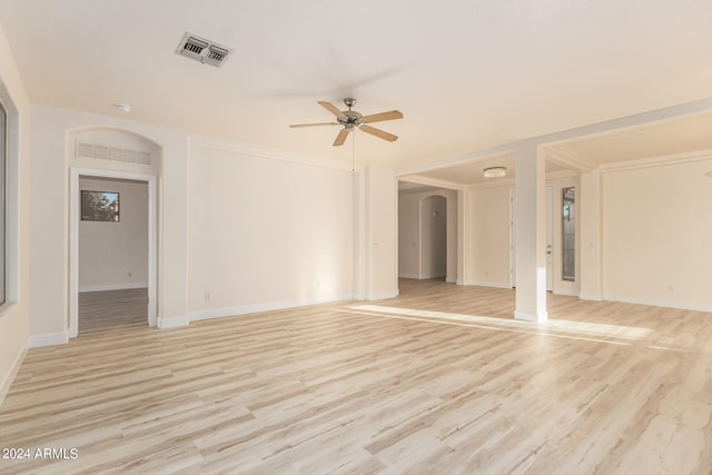 unfurnished living room featuring light hardwood / wood-style floors, ornamental molding, and ceiling fan