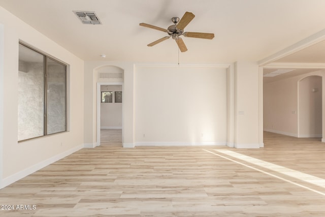 spare room featuring light wood-type flooring and ceiling fan