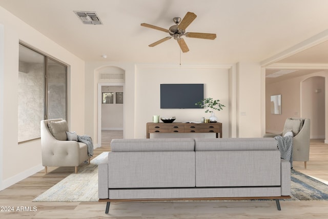 living room with light hardwood / wood-style floors and ceiling fan