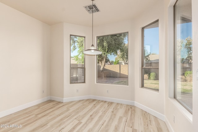 unfurnished dining area with light wood-type flooring