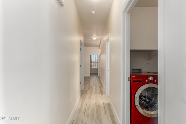 hallway featuring light hardwood / wood-style floors and washer / clothes dryer