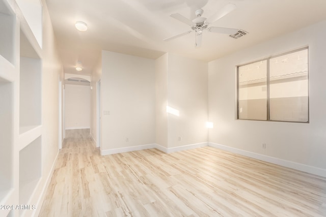 empty room featuring light wood-type flooring and ceiling fan