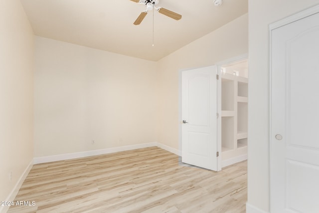 unfurnished room with ceiling fan, light hardwood / wood-style flooring, and lofted ceiling