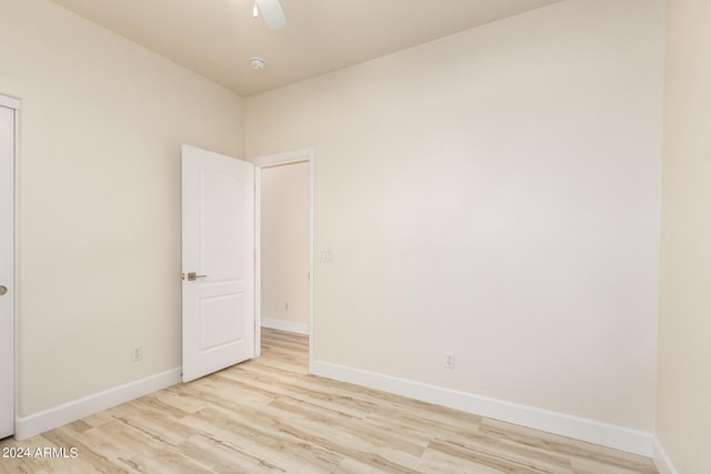 spare room featuring light hardwood / wood-style flooring and ceiling fan