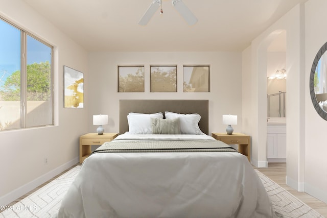 bedroom with ensuite bath, light hardwood / wood-style flooring, and ceiling fan