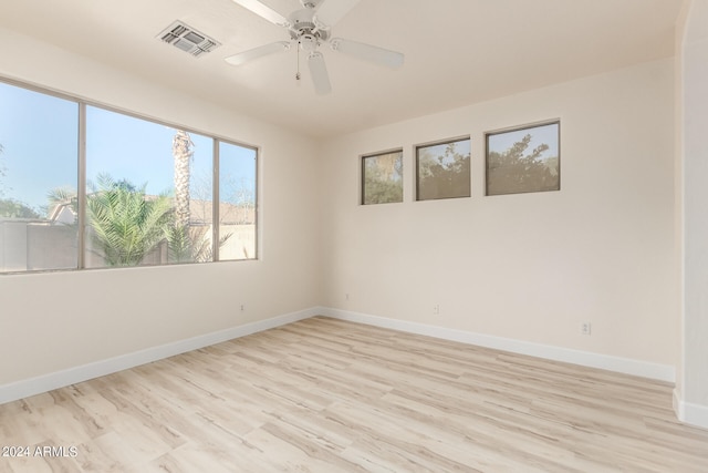 spare room featuring light hardwood / wood-style flooring and ceiling fan