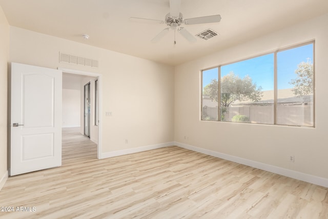 spare room featuring light wood-type flooring and ceiling fan