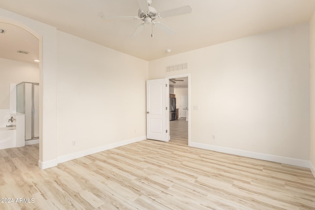 spare room featuring ceiling fan and light hardwood / wood-style flooring