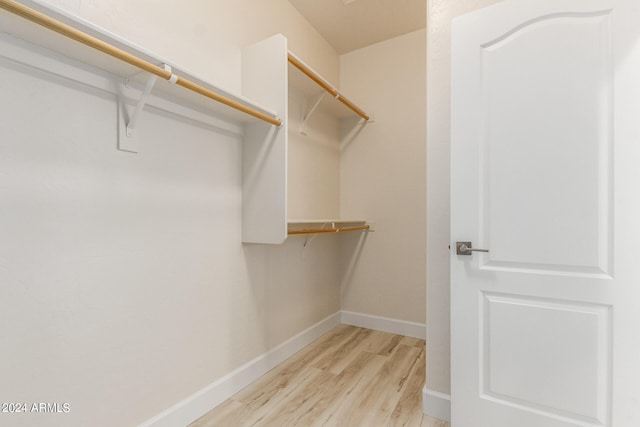 walk in closet featuring light hardwood / wood-style flooring