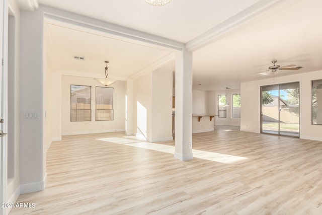 unfurnished living room featuring light hardwood / wood-style floors, ornamental molding, and ceiling fan