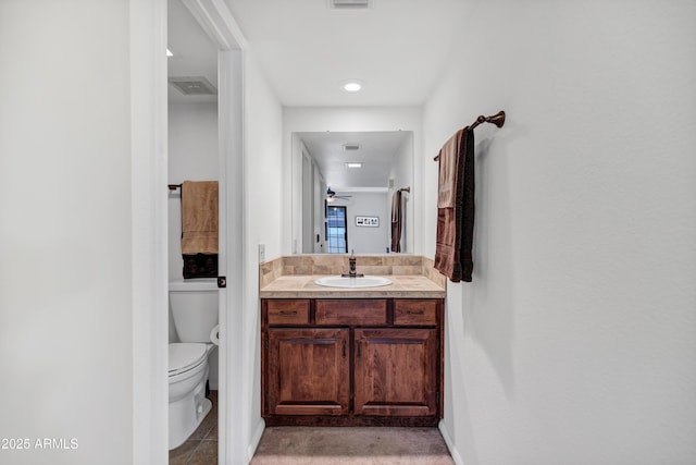 bathroom with toilet and vanity