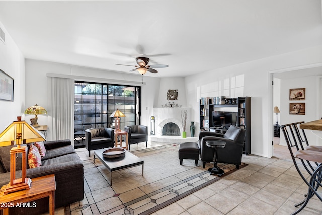 living room with ceiling fan and light tile patterned flooring