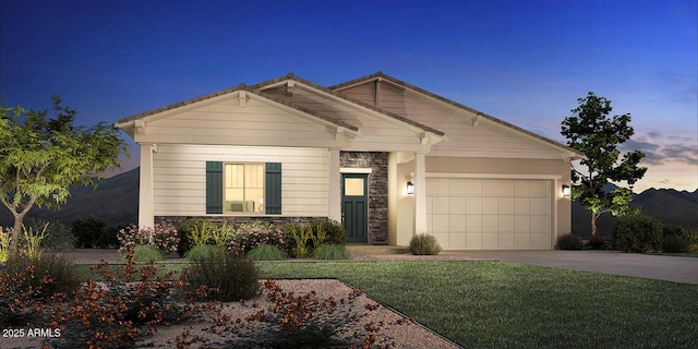 view of front of property with a garage and a yard