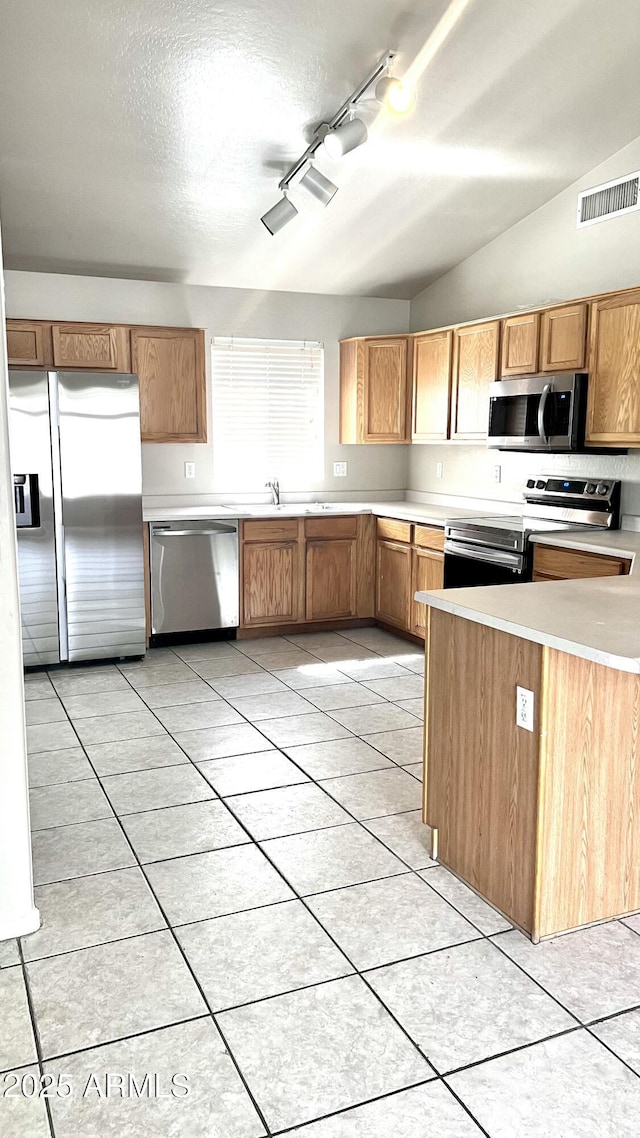 kitchen featuring light countertops, visible vents, rail lighting, and appliances with stainless steel finishes