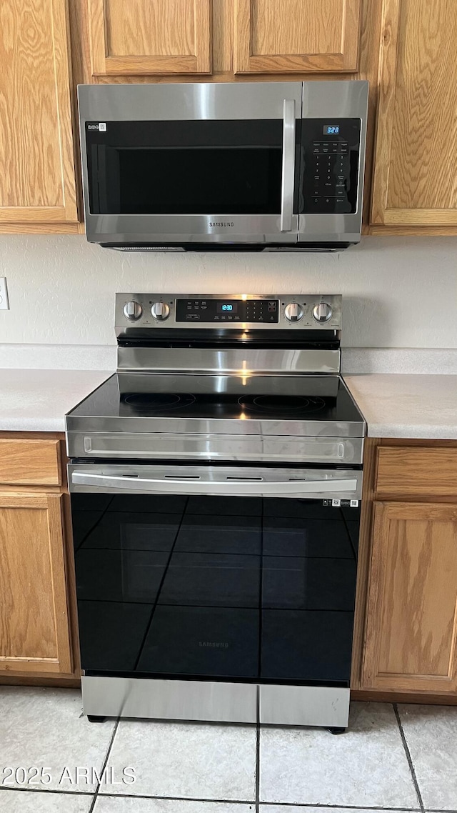 details featuring light countertops and appliances with stainless steel finishes