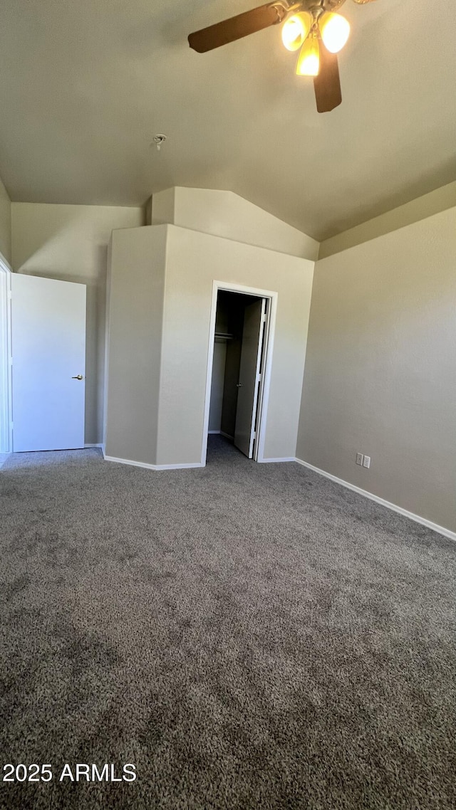 unfurnished room with carpet, ceiling fan, lofted ceiling, and baseboards