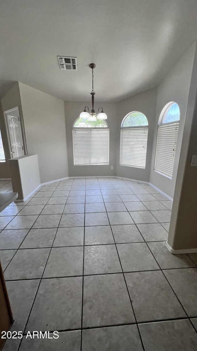 unfurnished dining area with visible vents, baseboards, and light tile patterned floors