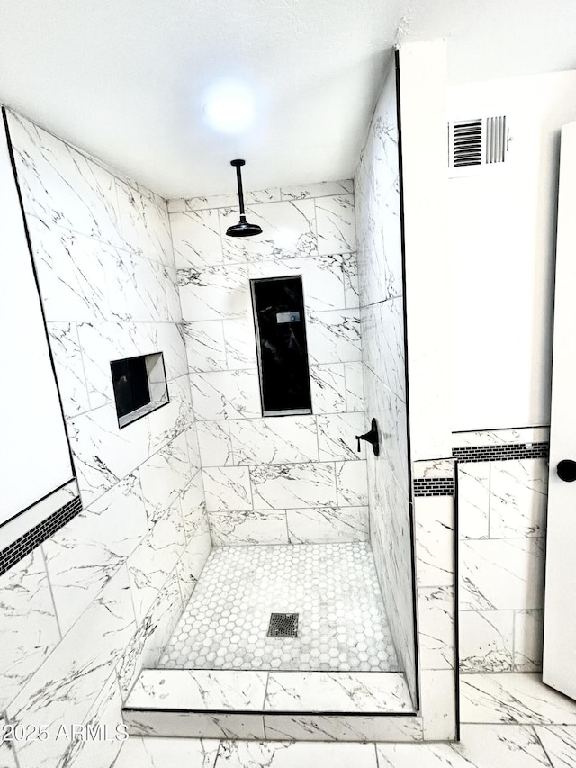 bathroom with a tile shower