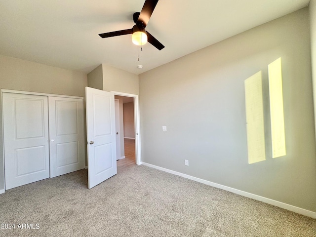 unfurnished bedroom featuring a closet, ceiling fan, and carpet