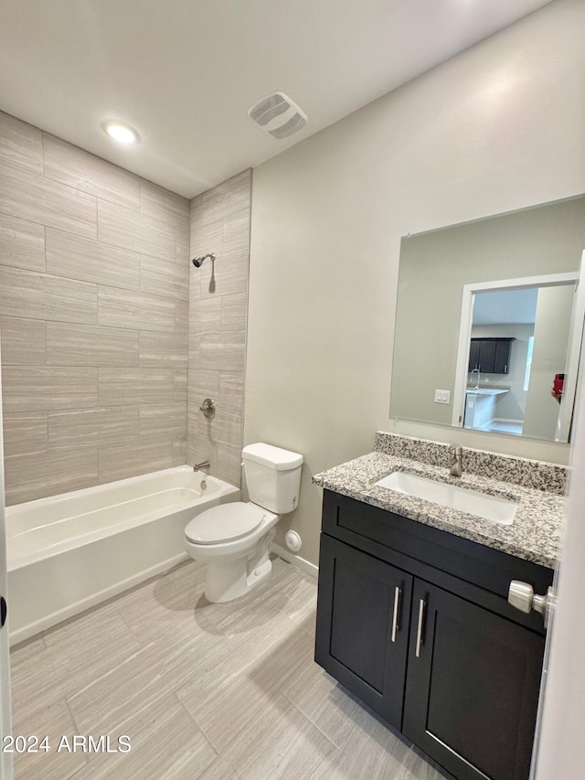 full bathroom with vanity, toilet, and tiled shower / bath