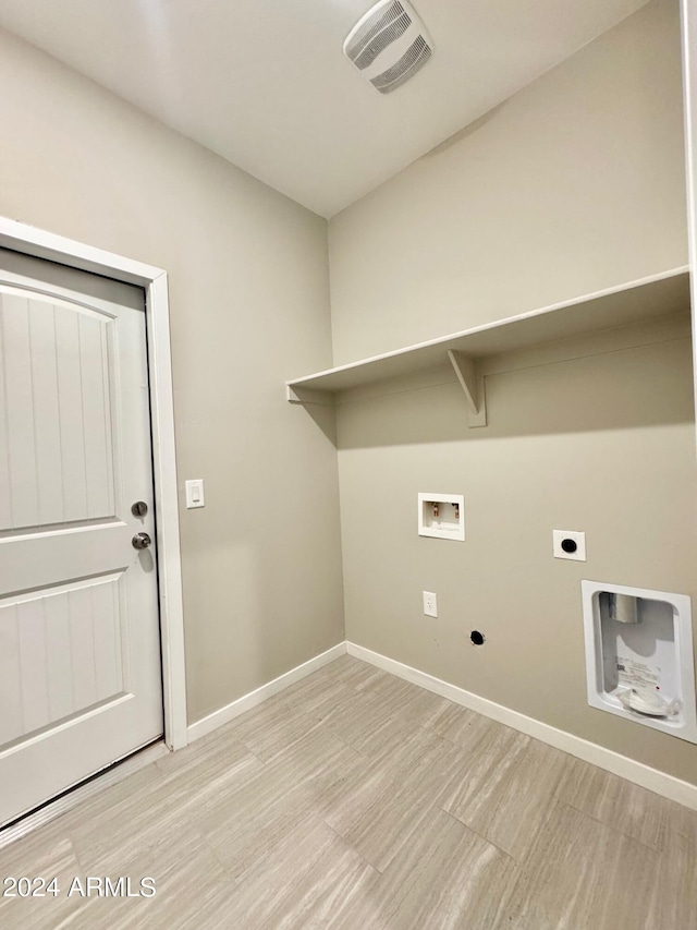 clothes washing area with hookup for an electric dryer, light hardwood / wood-style flooring, and hookup for a washing machine