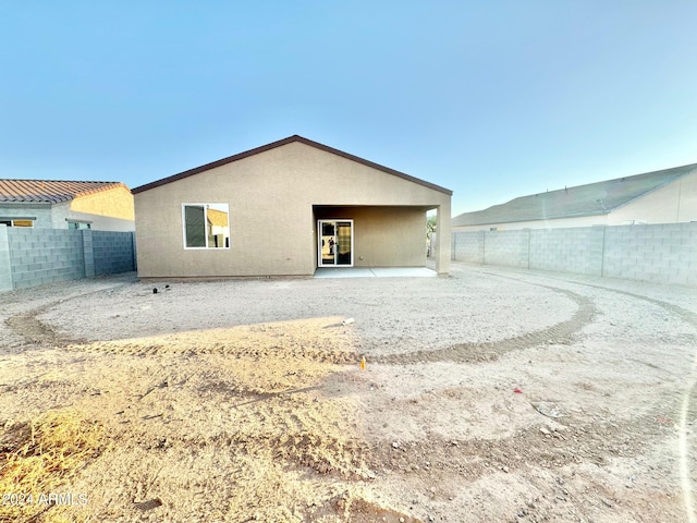 back of property with a patio