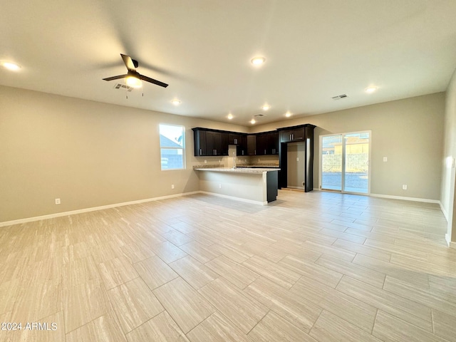 unfurnished living room featuring ceiling fan