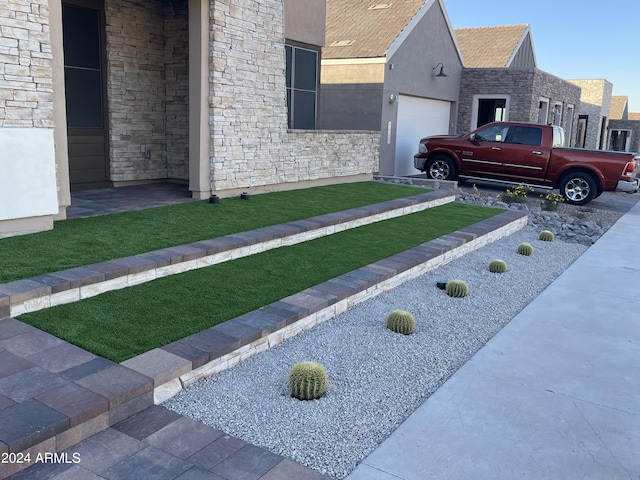 view of property exterior featuring a yard and a garage