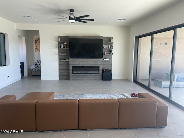 tiled living room featuring ceiling fan