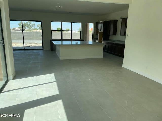 unfurnished living room featuring light tile patterned floors