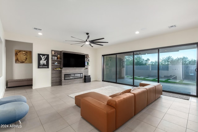 living room featuring light tile patterned flooring, radiator, and ceiling fan