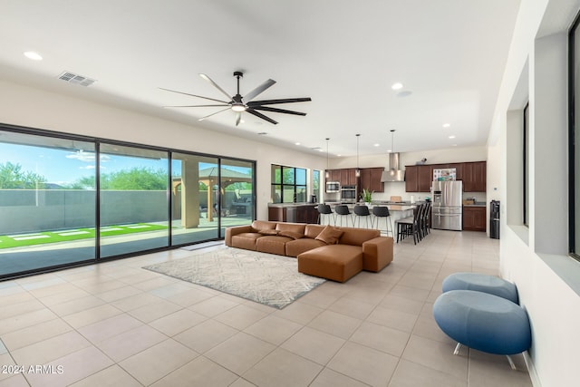 living room featuring ceiling fan and light tile patterned floors