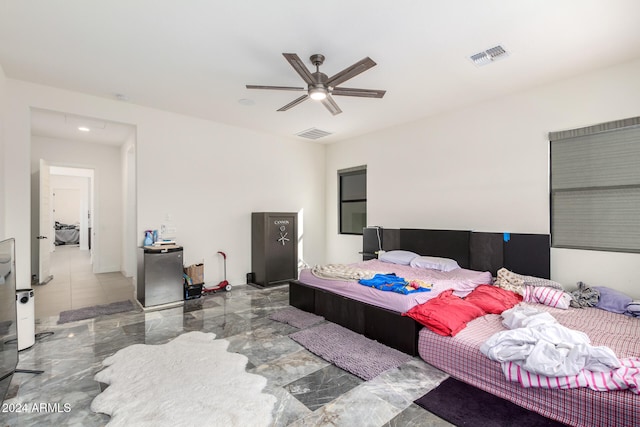 bedroom with stainless steel refrigerator and ceiling fan