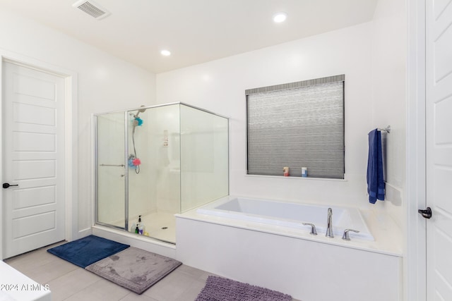 bathroom featuring tile patterned floors and shower with separate bathtub