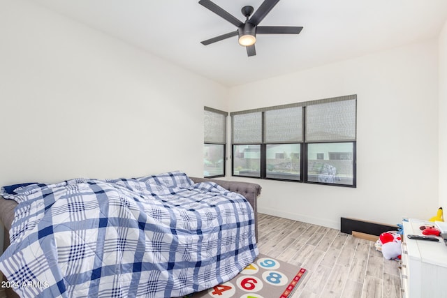 bedroom with light wood-type flooring and ceiling fan