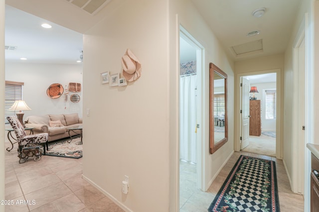 corridor with light tile patterned floors, visible vents, recessed lighting, and attic access