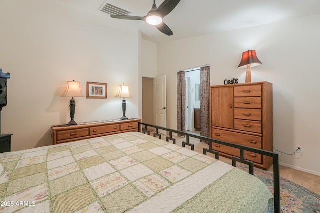 carpeted bedroom with vaulted ceiling, baseboards, visible vents, and ceiling fan