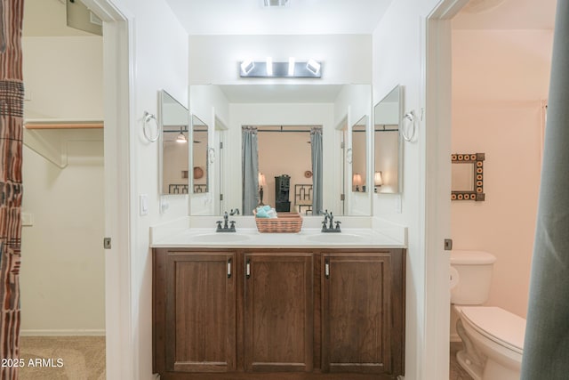 full bathroom featuring double vanity, toilet, visible vents, and a sink