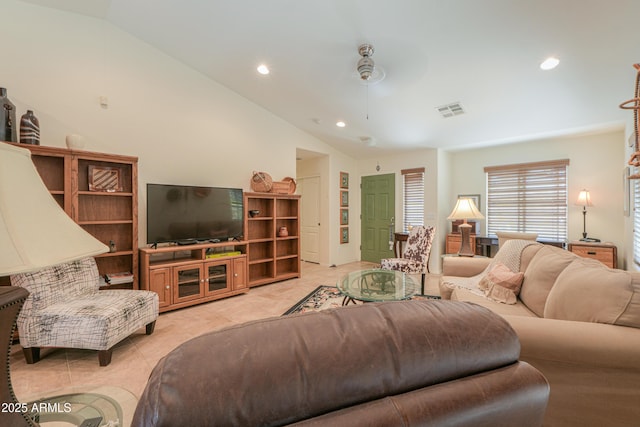 living room featuring light tile patterned flooring, visible vents, ceiling fan, and vaulted ceiling