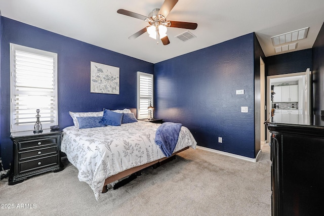 bedroom featuring multiple windows, ceiling fan, and light carpet