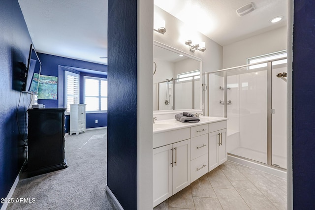 bathroom with vanity, tile patterned floors, and walk in shower