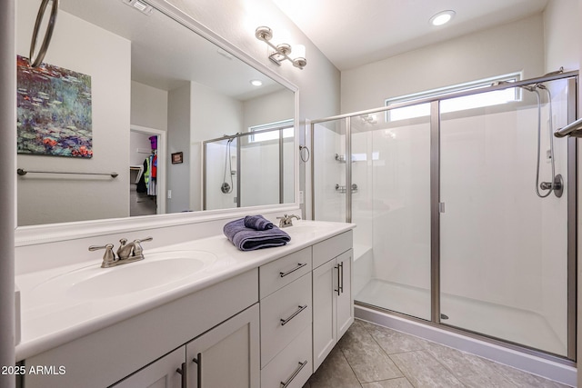 bathroom with vanity and a shower with shower door