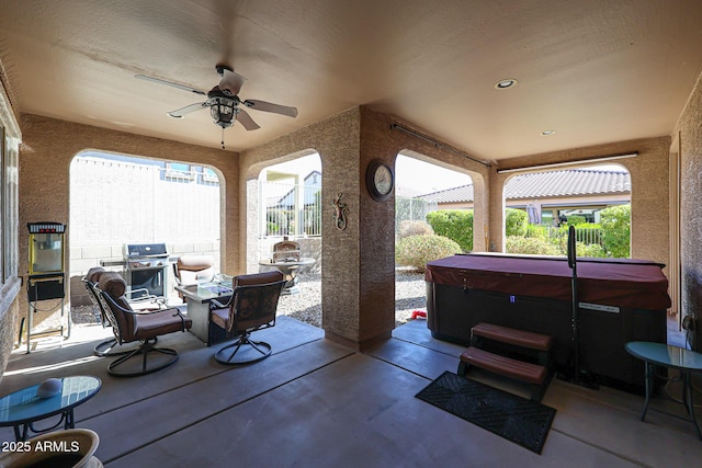 view of patio / terrace with a grill, a hot tub, and ceiling fan