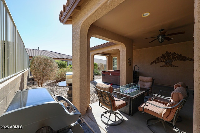 view of patio featuring a hot tub and ceiling fan