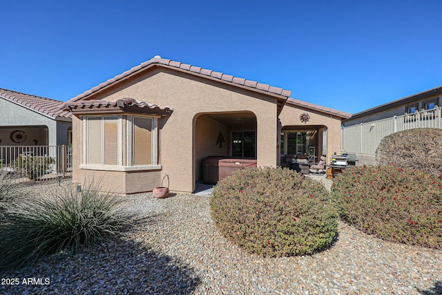 rear view of property featuring a patio area