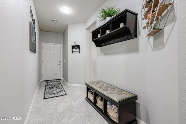 hallway with a textured ceiling